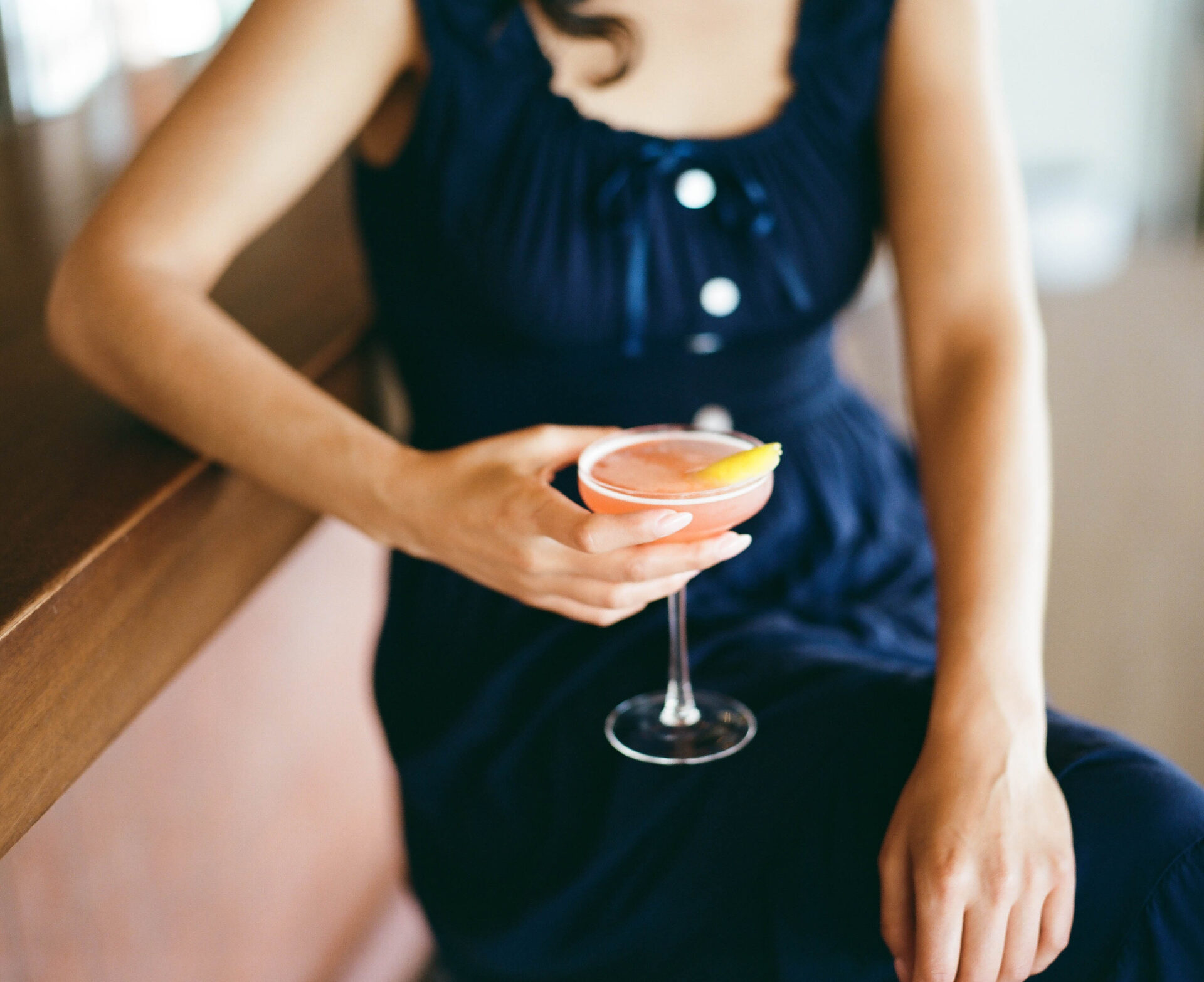 Woman drinking cocktail at Caravan Swim Club