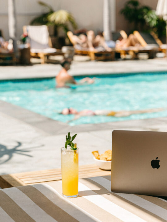 Working poolside with drink