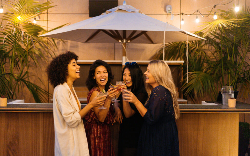 Girls enjoying cocktails at caravan swim club